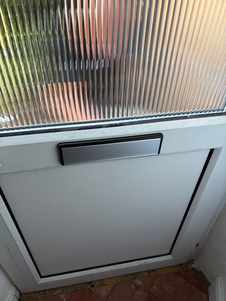 White UPVC door with a plain lower panel, silver letterbox and textured glass