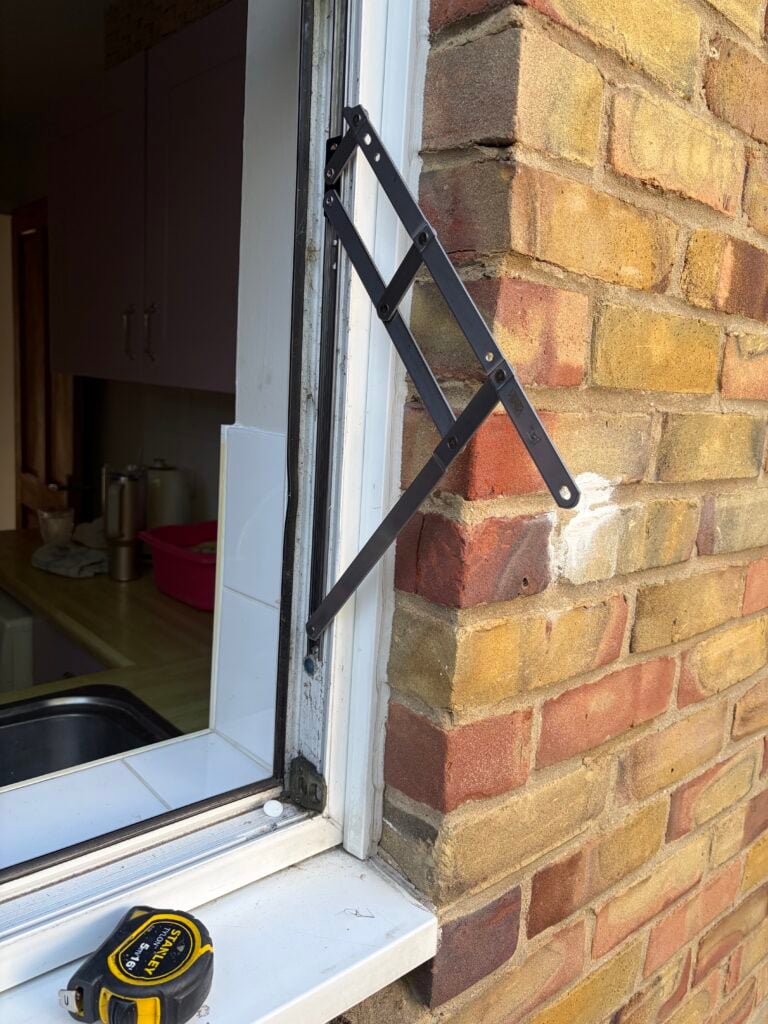 Extended friction hinge on a UPVC window frame with the sash removed