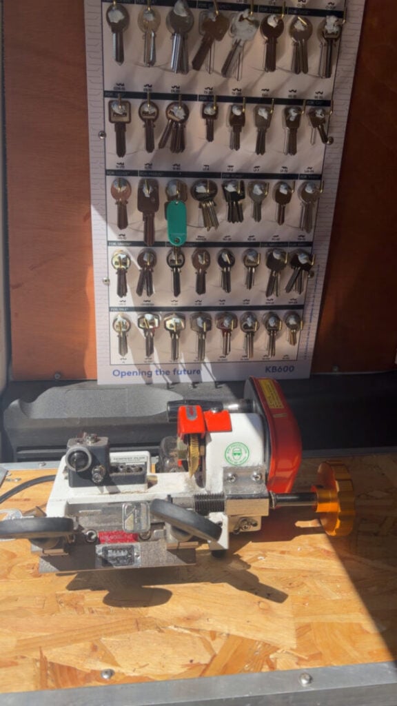 Key cutting machine and wall-mounted key blanks in a mobile workshop